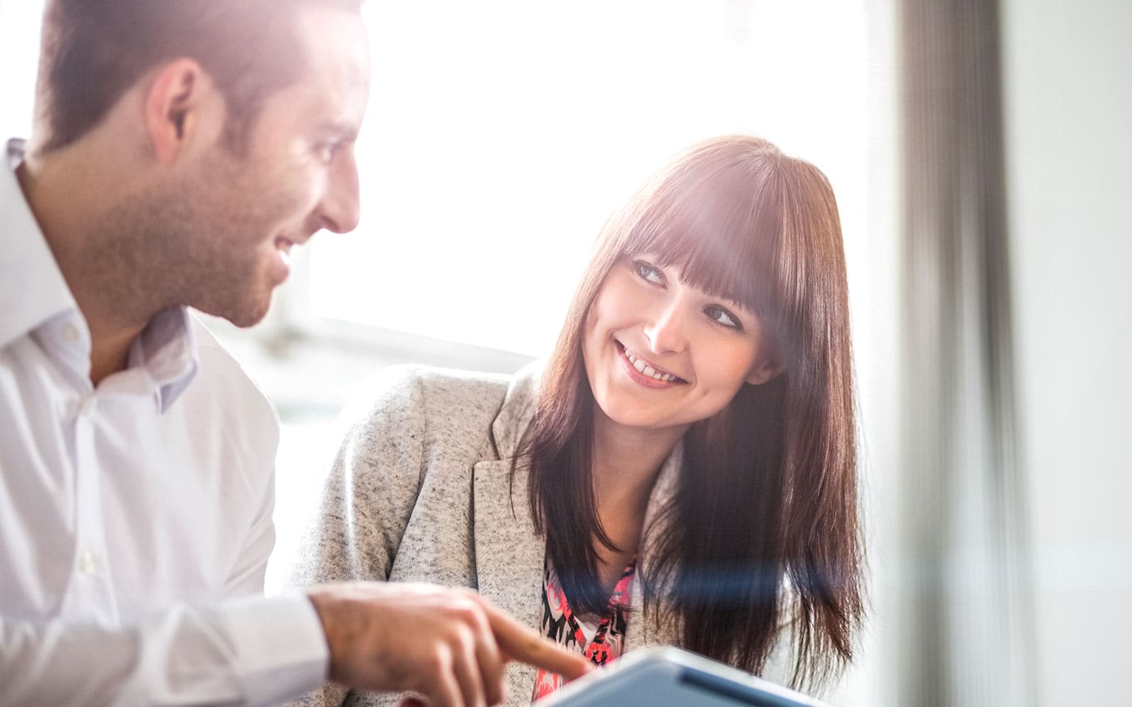 Woman and man looking at a tablet